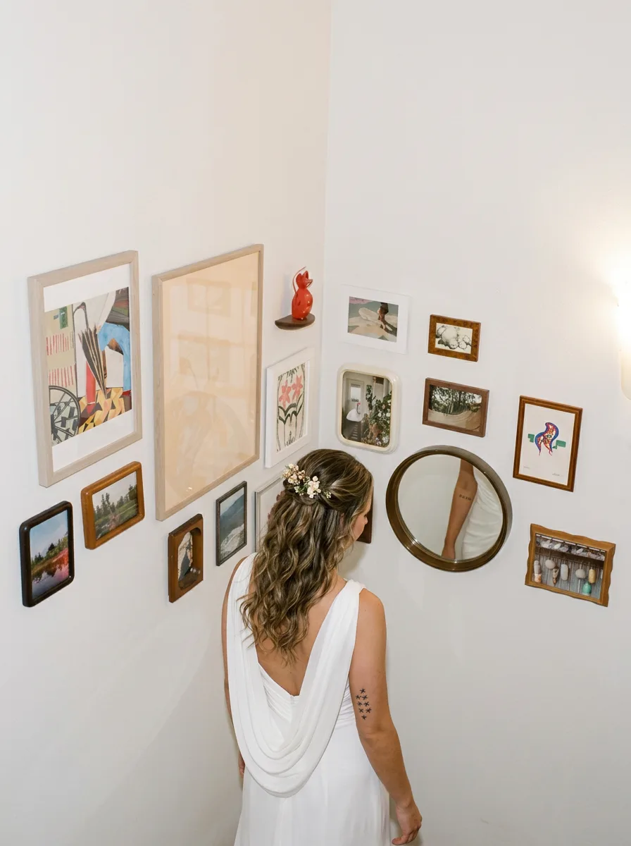 Bride on stairs past art wall
